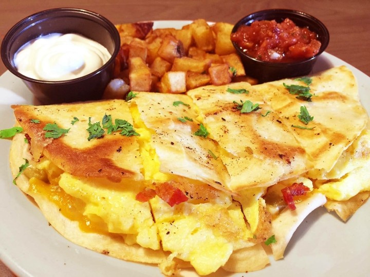 Scrambled eggs, bacon, cheese, jalapeños, wrapped in a flour tortilla topped with salsa and sour cream
